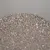 Close-up of grey, granular cat litter with various stone textures.