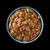 Bowl of wet pet food with brown chunks, orange and green vegetable pieces, and gravy in a blue dish, viewed from above