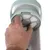 Hand showing how to remove or insert the filter of a device. Filter maintenance instructions visible.