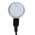 Vue rapprochée d’un accessoire circulaire transparent avec câble noir et connecteur USB visible, aucun texte ou marque apparente.