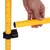 Yellow tube with measuring scale and black holder, hand shows connection between tubes.