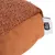 Gros plan sur un coussin ou jouet en tissu marron avec une étiquette portant la marque Tiaki, surface supérieure bouclée et base lisse.