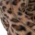 Close-up of brown faux fur material with leopard pattern and a brown seam.