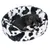 Dog lying in a black and white patterned dog bed with plush cover. 'Trixie' logo visible on the edge of the bed.