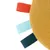 Close-up of a yellow fabric toy with three coloured loops: red, light blue and dark blue.