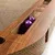 Toy made of wood and cardboard with two purple balls in a compartment. Visible materials: wood look and corrugated cardboard.