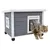 Grey wooden cat house with white frame and plastic flap door. Cat stepping out through the door.