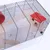 Small animal cage with metal grid, wooden platforms and red house. Suitable for keeping small rodents.