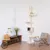 Cat tree with multiple levels, resting areas and a cave made of light wood and fabric. Placed in a modern living room with wooden furniture and plants.