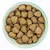 Bowl filled with triangular-shaped dry pet food pieces, showing size and texture of the kibble.