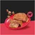 Chunky wet food in cubes and slices on a red plate, next to it a symbol with a silhouette of a cow. Chunky wet food in cubes and slices on a red plate, next to it a symbol with a silhouette of a cow.