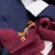 Close-up of small, brown dog snacks shaped like bones, embedded in fabric with blue and red felt.