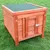 Wooden dog kennel with green roof and metal latch, suitable for outdoor use.