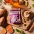 Forthglade calming soft bites with camomile, lavender and lemon balm, grain free, shown with sweet potato, ginger, herbs and treats on a wooden board.
