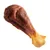 Friandise en forme de cuisse de poulet, partie supérieure marron et extrémité beige, sans marque visible ni texte.