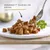 GOURMET™ Dadini in salsa, cubetti di alimento umido su piatto bianco con forchetta e rametto di prezzemolo. Testo visibile: GOURMET™ DADINI IN SALSA.