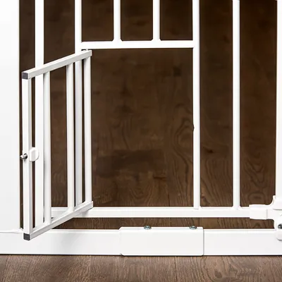 White metal safety gate with small opening, suitable for pet areas or safety zones. Gate mounted on wooden floor.