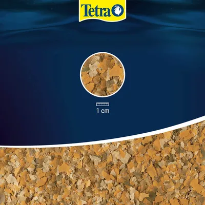 Tetra vločkové krmivo pre ryby, detailná ukážka veľkosti vločiek s mierkou: 1 cm.