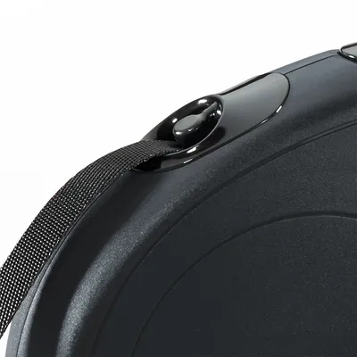 Close-up of a retractable lead handle showing the release button and attached black strap.