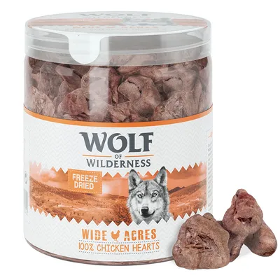 Wolf of Wilderness Wide Acres 100% Chicken Hearts, lyofilizované kuracie srdcia v plastovej dóze, nápis Freeze Dried na etikete, viditeľné kúsky produktu vedľa obalu.