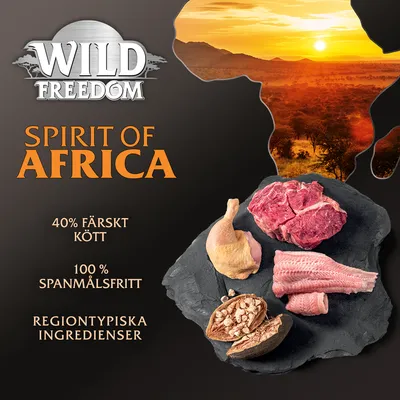 Wild Freedom Spirit of Africa, 40 % färskt kött, 100 % spannmålsfritt, regiontypiska ingredienser. Bild på rått kött, fågel, fisk och nötter på svart skiffer.