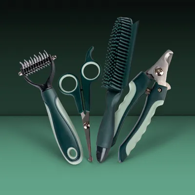 Set of grooming tools: dematting comb, scissors, brush and claw cutter in green-black design.