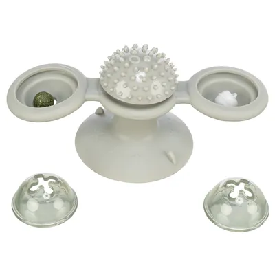 Jouet interactif gris en plastique avec ventouse, deux compartiments latéraux contenant une balle et un objet blanc, dôme central à picots, deux couvercles transparents amovibles.