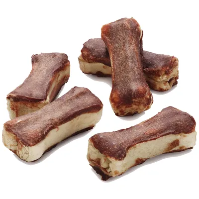 Image showing five brown and beige bone-shaped chew treats arranged on a white background, displaying their texture and size for product identification.