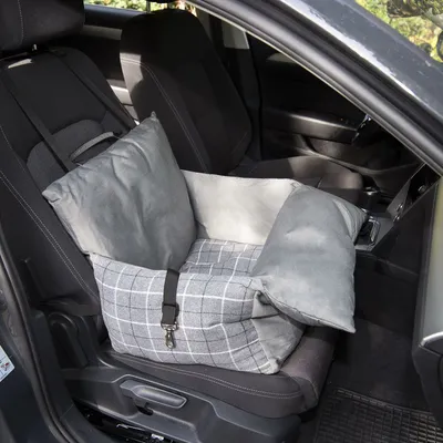 Grey car seat cushion with check pattern and safety belt, placed on a car seat. Suitable for safe transport of pets in the car.