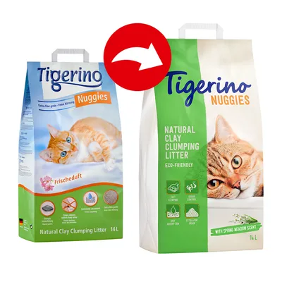 Cambio de envase de Tigerino Nuggies arena aglomerante para gatos, 14 L. Texto visible: 'Natural Clay Clumping Litter', 'Eco-Friendly', 'With Spring Meadow Scent'. Imagen de gato naranja.