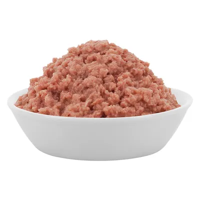 Miska s nasekaným červeným mokrým krmivem. Konzistence ukazuje jemné kousky.