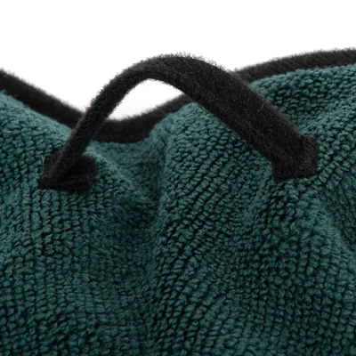 Close-up of green fabric material with black felt handle, suitable for transport or handling.