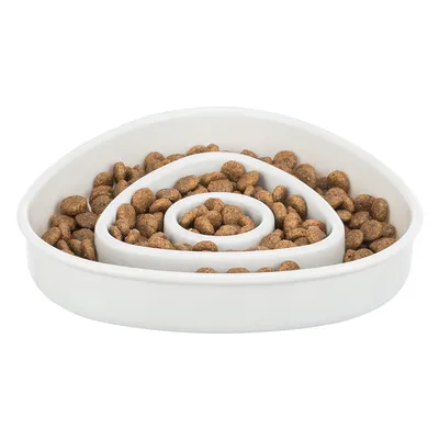 White feeding bowl with spiral design, filled with brown dry food pieces. Encourages slow eating through obstacles.