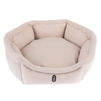 Tiaki beige huisdierenbed met gewatteerde zijkanten en zacht ligoppervlak.