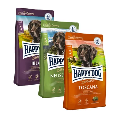 Kolme Happy Dog Sensible -koiranruokapussia: Toscana, Neuseeland ja Irland. Jokaisessa pussissa koiran kuva, merkintä Adult, 11 kg+ sekä näkyvät maut ja tuotetiedot.