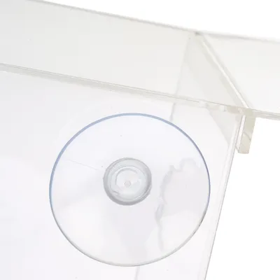 Close-up of a transparent suction cup on a clear plastic surface.