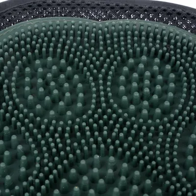 Close-up of a green rubber brush with spiral-shaped nubs, suitable for coat care.