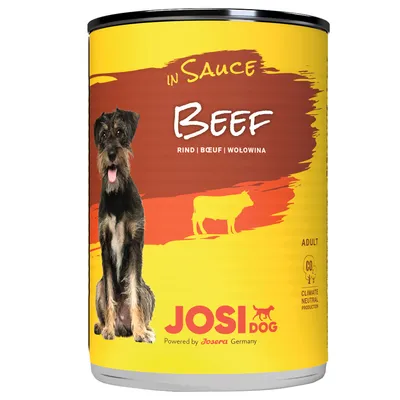 Boîte de nourriture pour chien JosiDog, bœuf en sauce, texte visible : Rind | Bœuf | Wołowina, Adult, Climate neutral production, Powered by Josera Germany, image de chien et vache.