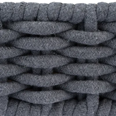Close-up van een grijs, gevlochten textielmateriaal met dikke structuur.