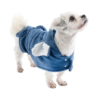 Small dog wearing a blue fleece coat with white ears and press studs. Product shows coat for pets.