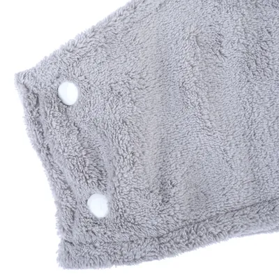 Grey, soft fabric with two white press studs, suitable for fastening or closure.