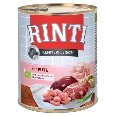 Rinti Kennerfleisch blik met zichtbare tekst: 'Mit Pute', 'NEU noch mehr natürliche Fleischstücke'. Afbeelding van verschillende stukken vlees op de verpakking.