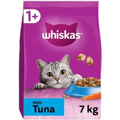 Bag showing Whiskas 1+ with tuna, 7 kg. Image includes food pieces, a blue bowl of dry food, peas, carrot and a grey tabby cat.