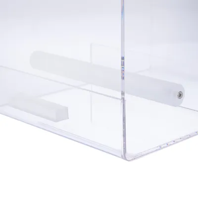 Transparent box made of plexiglass with white plastic rod and rectangular insert. Visible screw at the end of the rod.