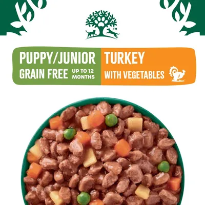 Puppy or junior grain free turkey with vegetables, suitable up to 12 months. Image shows chunks of food with peas and carrots.