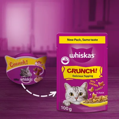 Image showing Whiskas Crunch topping changing from old to new packaging, with text 'New Pack, Same taste', 100g, and flavour details: with chicken, turkey and duck.