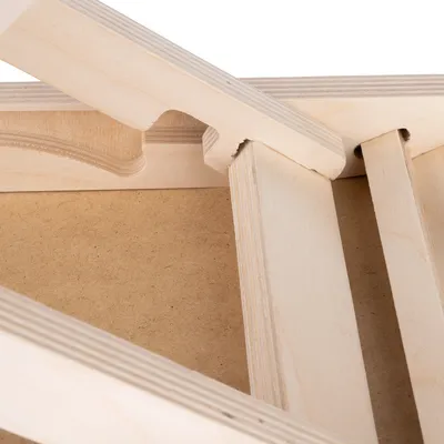 Close-up of a wooden frame with precise cut-outs and smooth finish, suitable for furniture or accessory assembly.