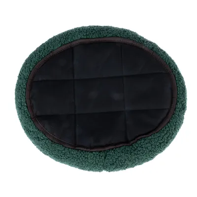 Round, padded pet cushion with black surface and green edge made of soft fabric.