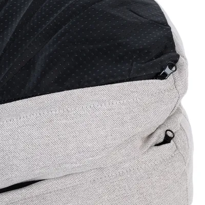 Close-up of a grey fabric cover with black non-slip underside and zips.