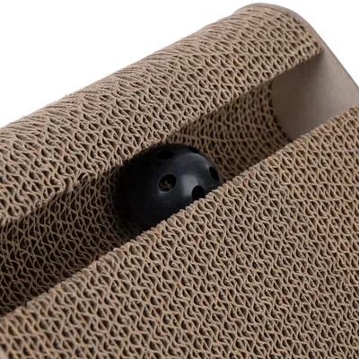 Scratching toy made of corrugated cardboard with a black ball with holes in a recess.